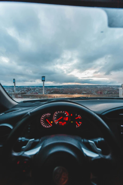 view from inside a car looking at the dashboard, in a road