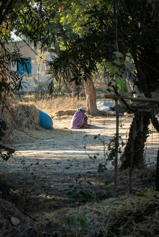 two young children sitting down and having fun in the sun