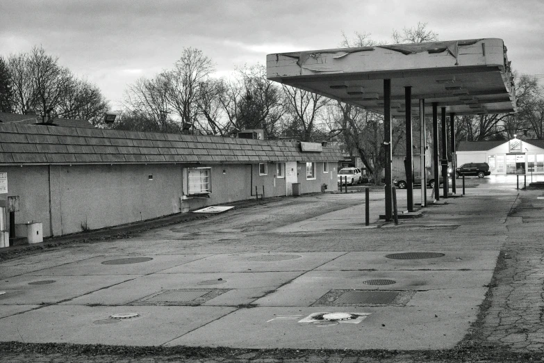 the empty parking lot at the gas station has been empty