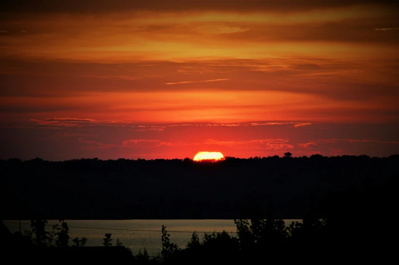 sunset with setting sun over a body of water