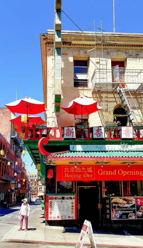 a small business with red umbrellas in the front and side