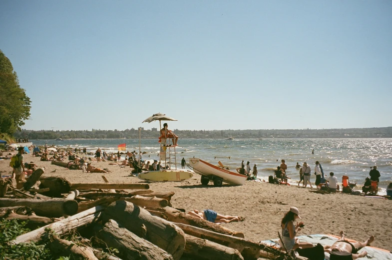 people enjoy the day at the beach with a large boat