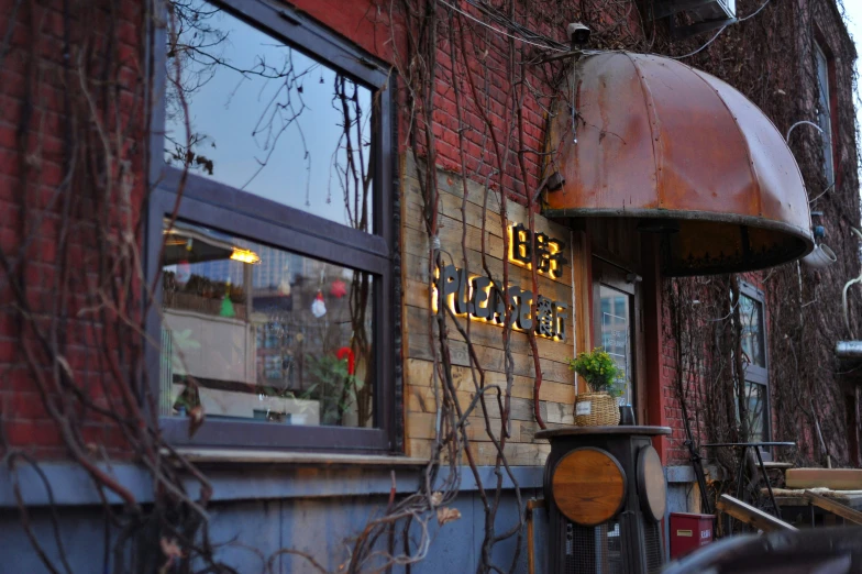 outside view of a restaurant with brick and metal