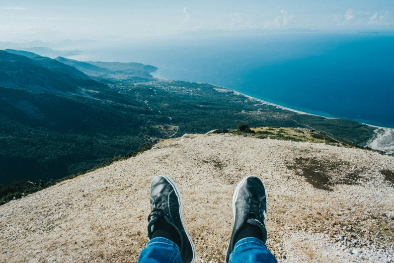 a person's feet are standing on the ground