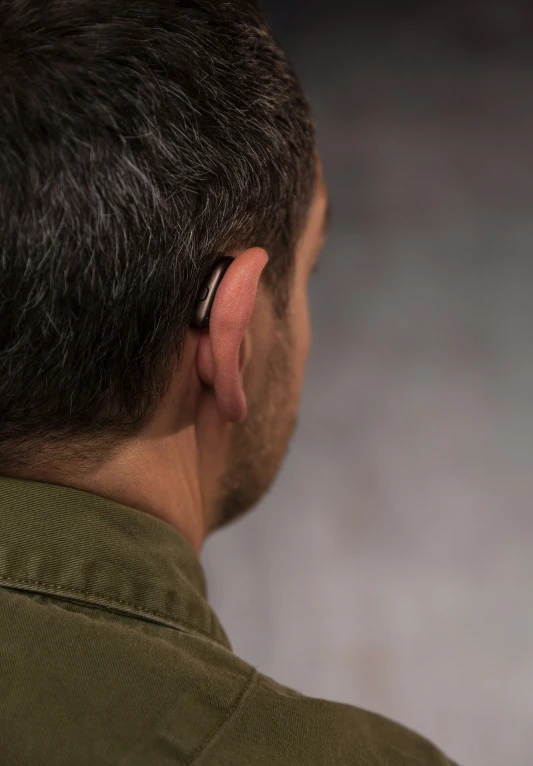 a man wearing a pair of earphones standing up