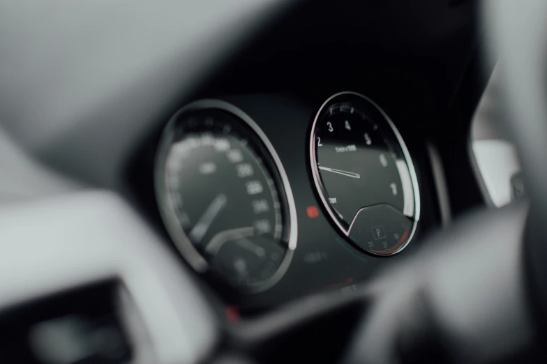 a dash board with three gauges in the center of it