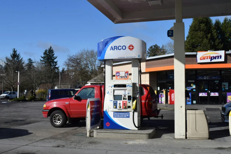 two cars are parked at an electric gas station