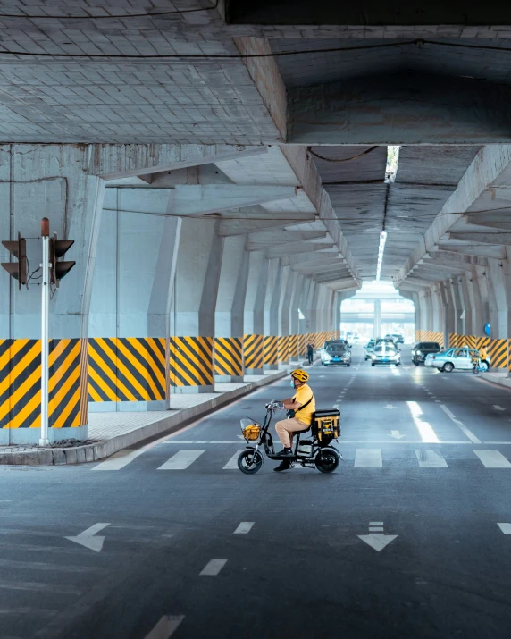 a person on a motor bike in a long bridge