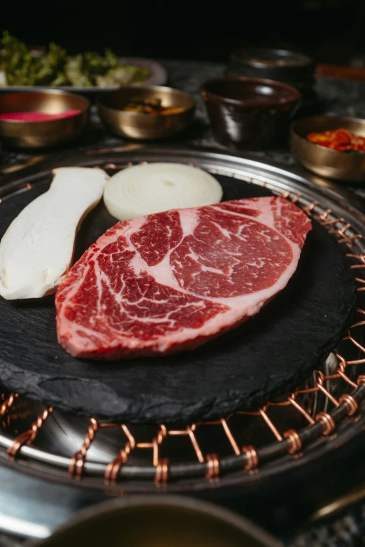 some raw meat is sitting on a round plate