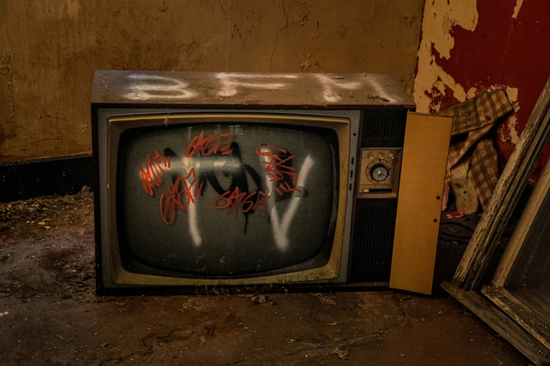 a television sitting next to other objects on the floor