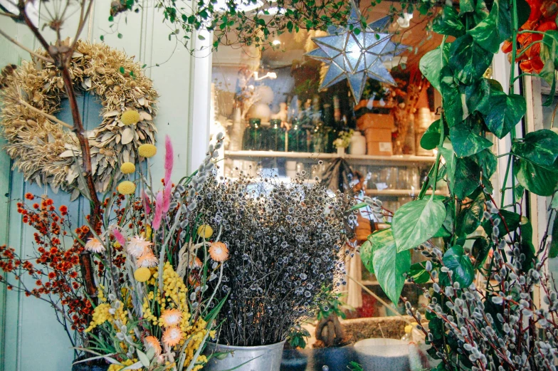 a close up of two metal buckets filled with flowers