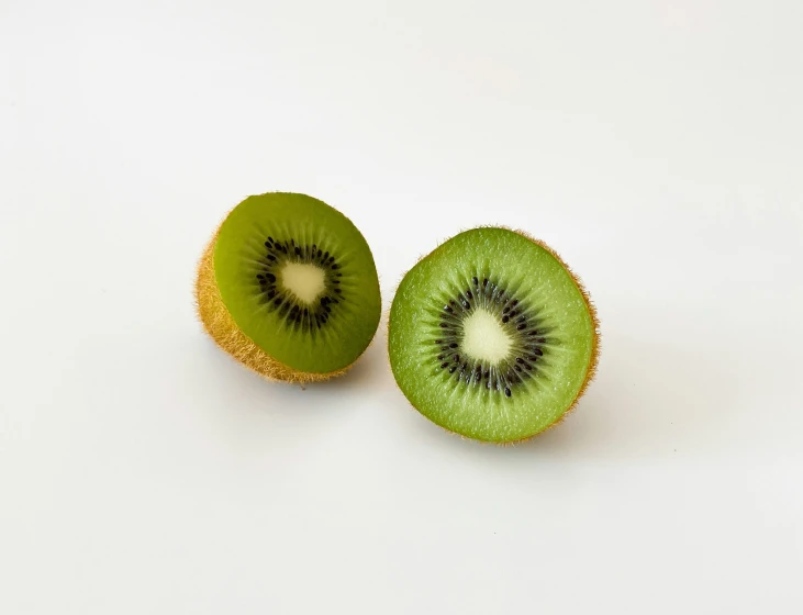 a cut in half kiwi sitting on top of a table