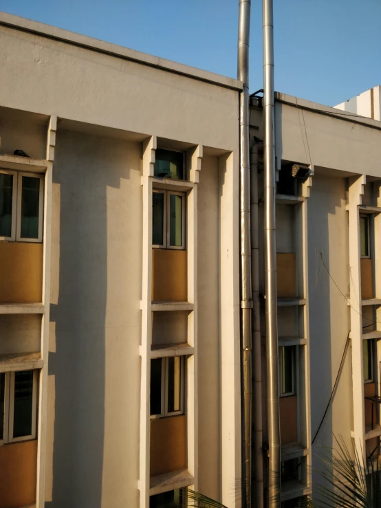 a building with large windows next to other buildings