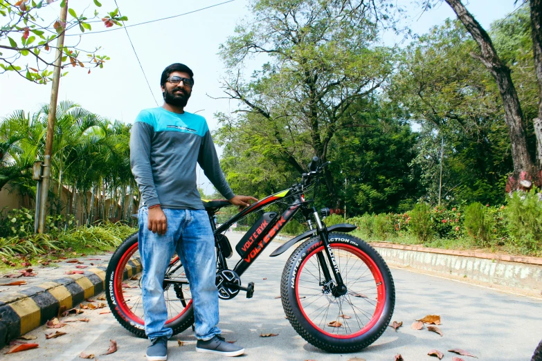 a man standing with a mountain bike outside