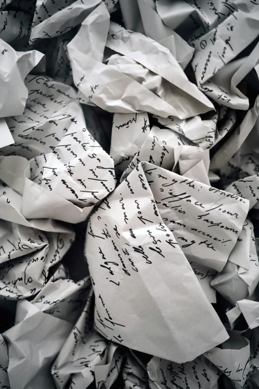 a pile of old newspaper papers with writing on it