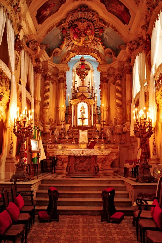 an image of a church with stairs and red seats
