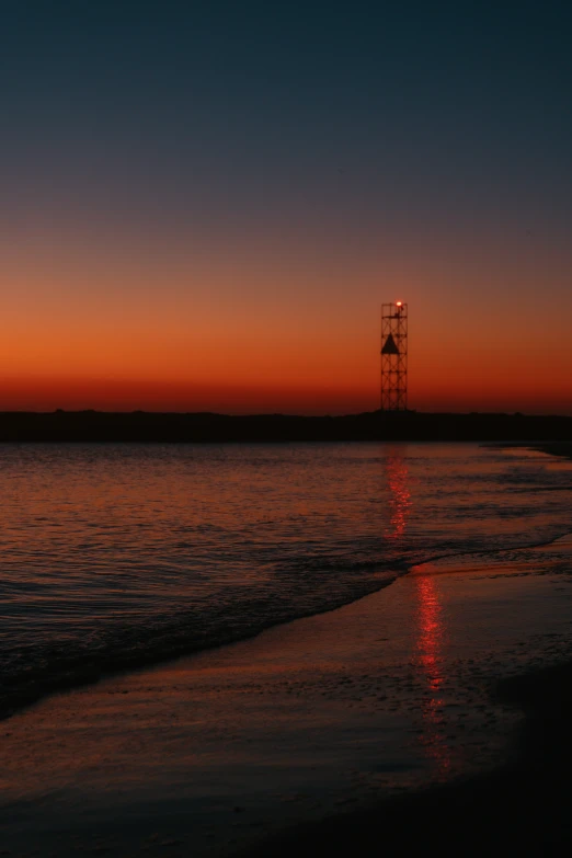 an empty beach with the sun going down