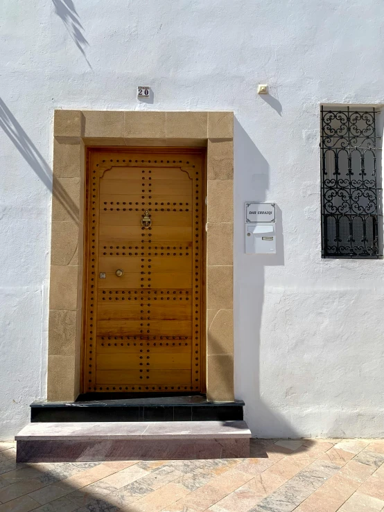 a brown door sits on a white building