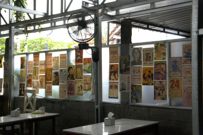 a table under a large metal structure with a lot of pictures on it