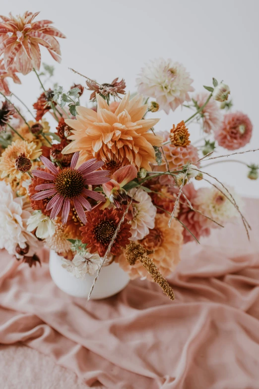 a bouquet of flowers sits atop the cloth