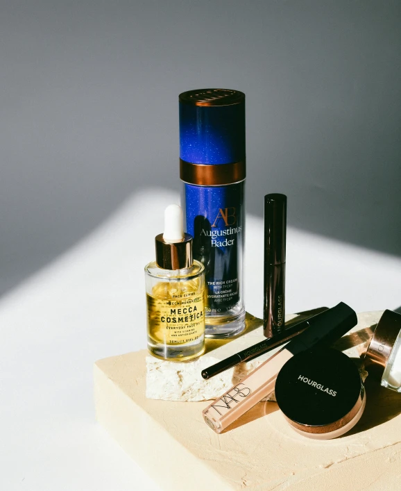 a white counter holding cosmetics bottles and a compact jar