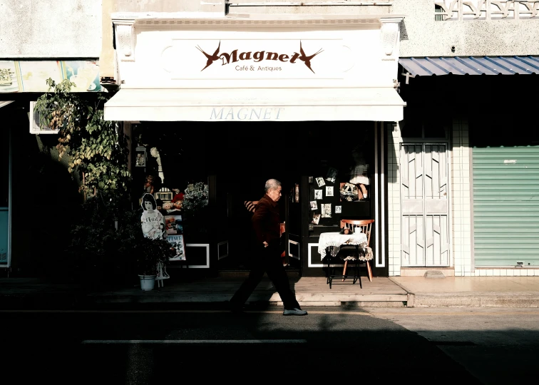 a couple walking across a street in front of a building