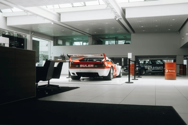 a large car sits in an indoor garage