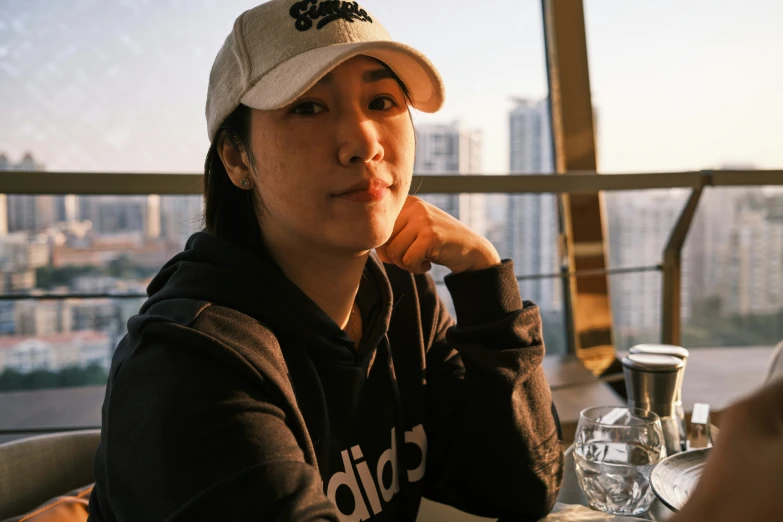 a woman sitting at a table with her head resting on her hand