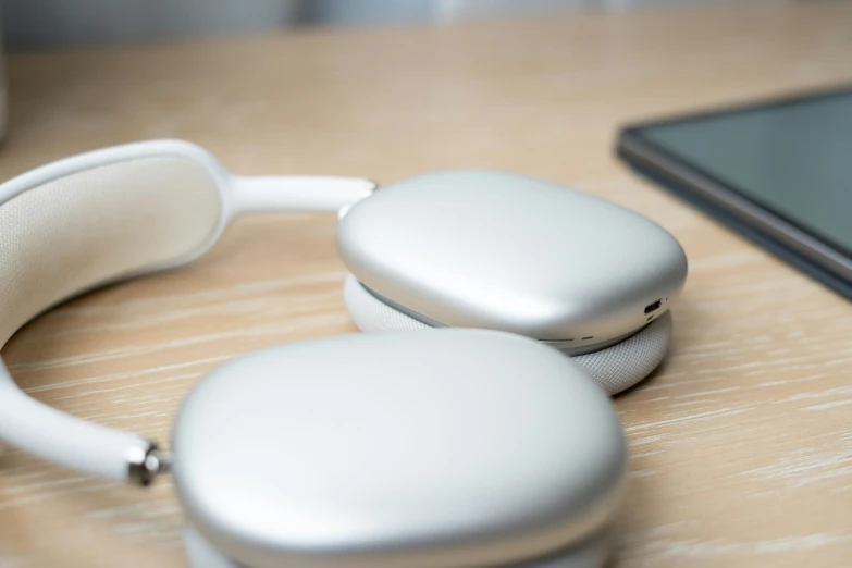 a couple of white headphones sitting next to a laptop