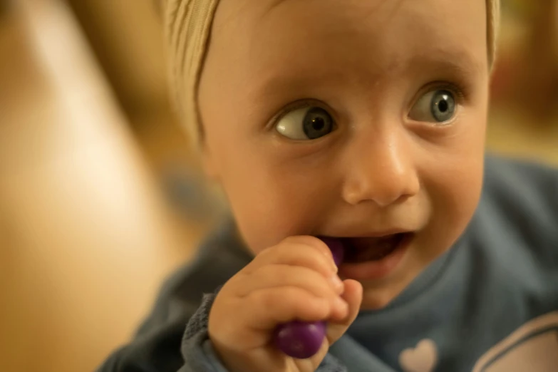 a close up of a child with a toothbrush