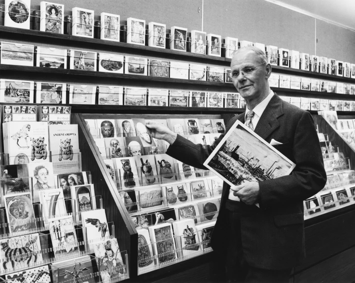 man standing in front of shelf with magazine covers