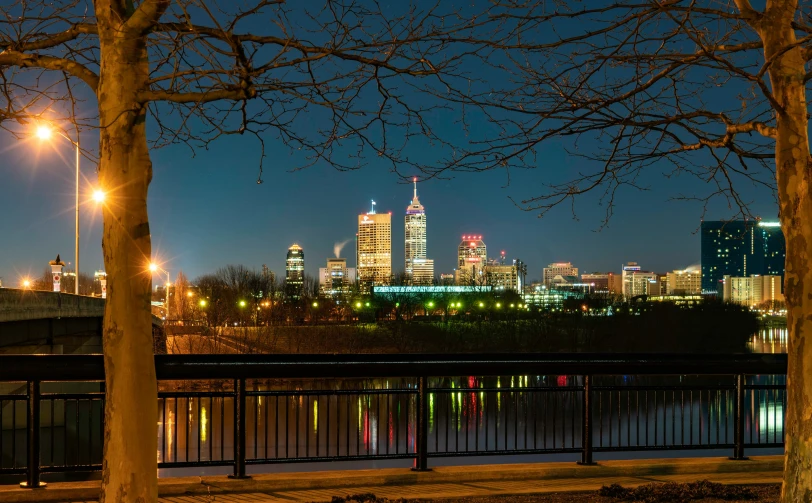 the city skyline is lit up at night and it's all bright