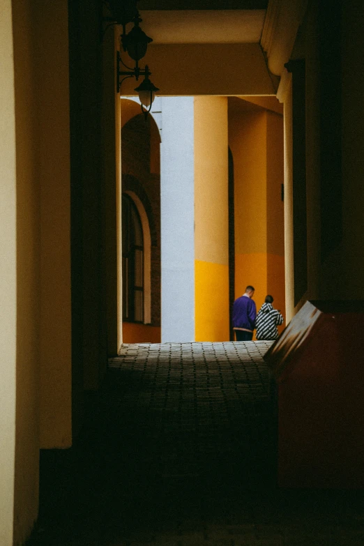 a man is sitting on a bed in an open area