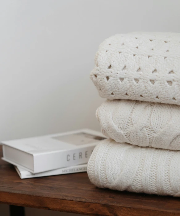 a stack of white folded towels on a table