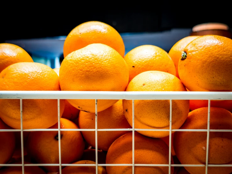 a bunch of oranges piled together in a pile