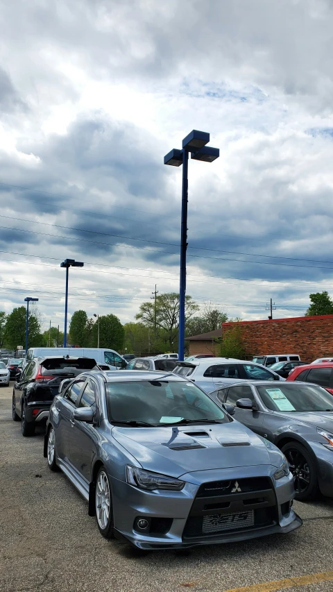 several cars are parked side by side in a lot