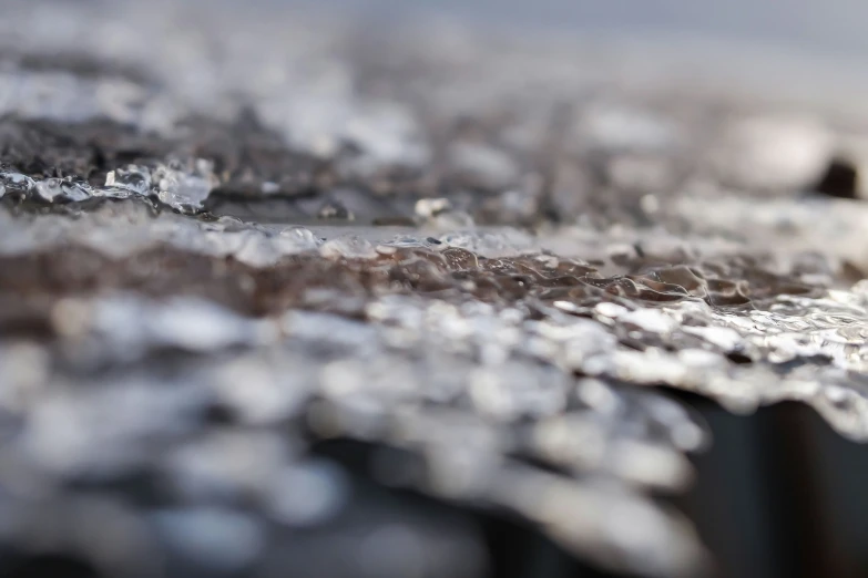 closeup s of ice crystals on top of metal