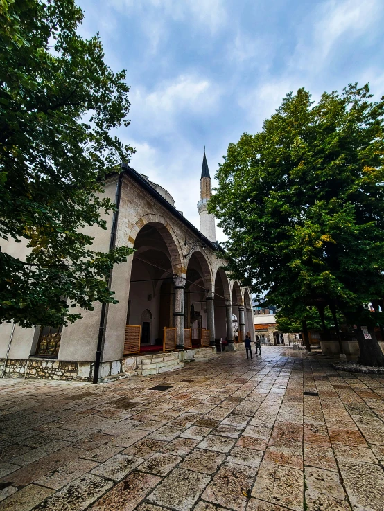 a large building in front of some trees