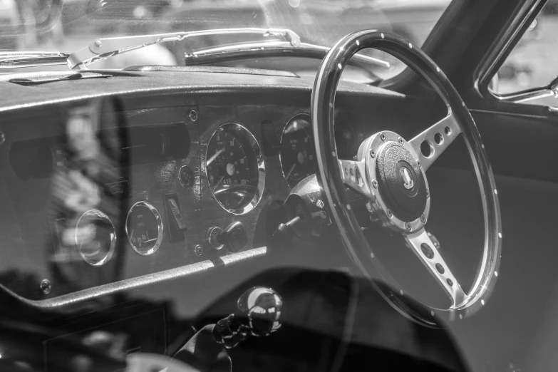 the dashboard on a classic car with the steering wheel and dash