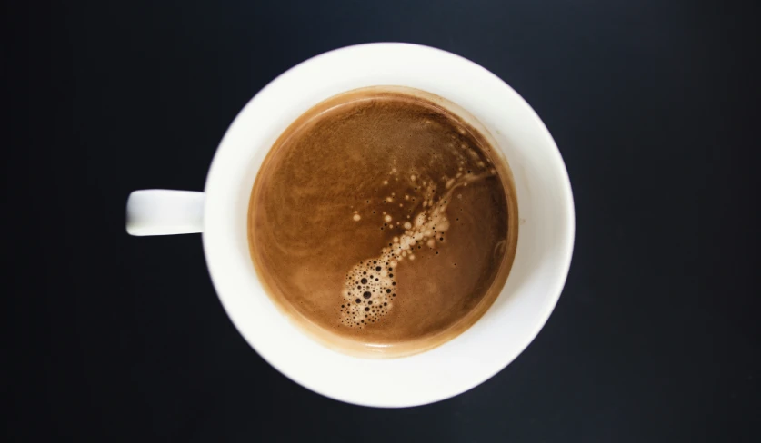 a cup of  chocolate on a black background