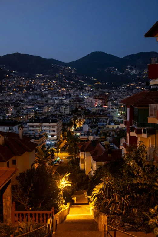 a night view of a residential area and mountains