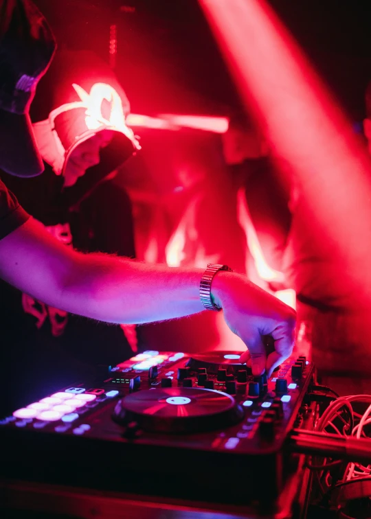 a dj playing the decks on top of a sound equipment set