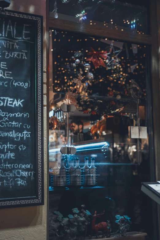 the chalk board is beside a sign outside a restaurant