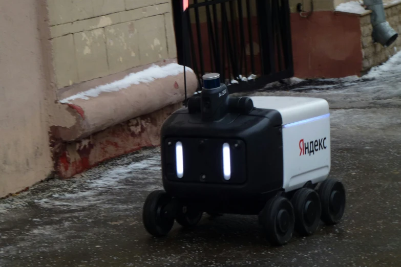 an appliance robot is driving along the street